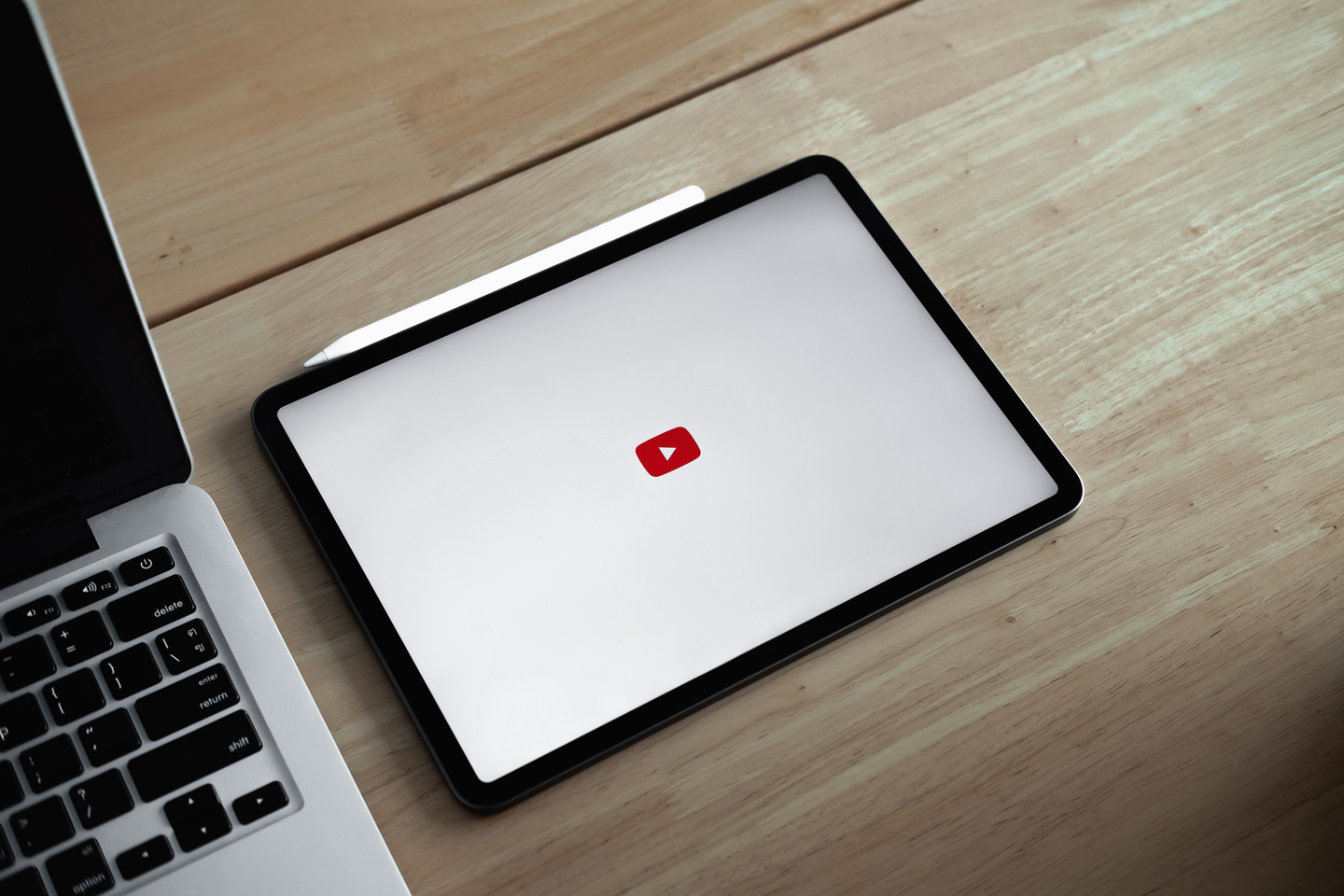 Mac Book on Table with Youtube Logo 